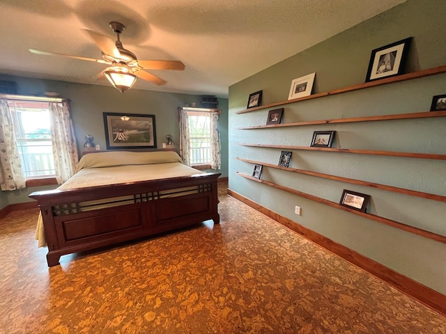 bedroom featuring a textured ceiling and baseboards