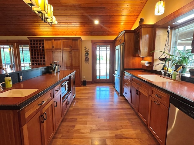 kitchen featuring dark countertops, wooden ceiling, appliances with stainless steel finishes, and a sink