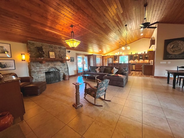 living area with lofted ceiling, wooden ceiling, light tile patterned flooring, a fireplace, and a ceiling fan