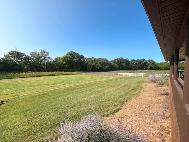 view of yard with a rural view and fence