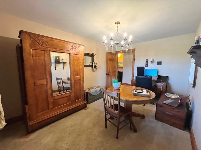 dining space featuring light carpet and an inviting chandelier