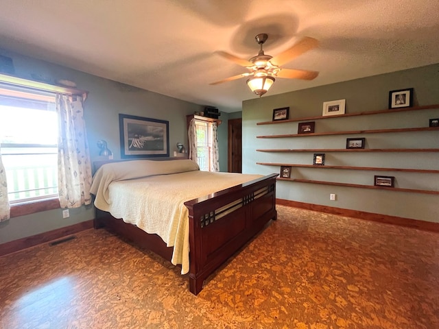 bedroom with baseboards, visible vents, and a textured ceiling