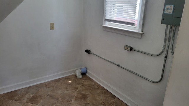 1408 S Downing, Kirksville, MO 63501 - laundry room with baseboards and dark tile patterned flooring