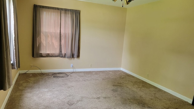1408 S Downing, Kirksville, MO 63501 - carpeted empty room with baseboards and ceiling fan
