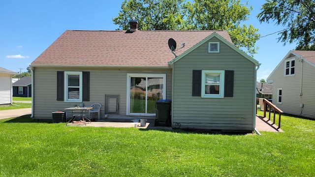 1408 S Downing, Kirksville, MO 63501 - back of house featuring a chimney, a lawn, roof with shingles, and a patio