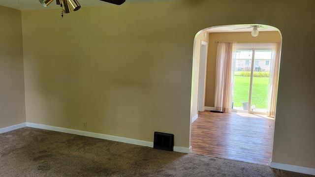 1408 S Downing, Kirksville, MO 63501 - carpeted empty room with ceiling fan and arched walkways