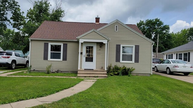 1408 S Downing, Kirksville, MO 63501 - bungalow-style home with a chimney, a front yard, and roof with shingles