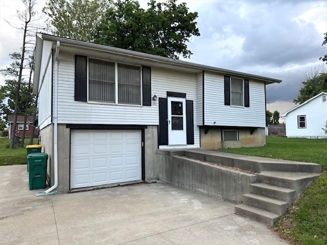1201 Maffry St, Macon, MO 63552 - bi-level home with driveway, an attached garage, and a front yard