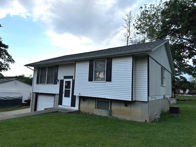 1201 Maffry St, Macon, MO 63552 - raised ranch with a front lawn, an attached garage, and concrete driveway