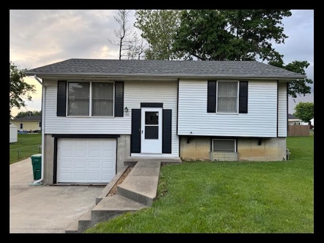 1201 Maffry St, Macon, MO 63552 - bi-level home featuring a front yard, an attached garage, driveway, and roof with shingles