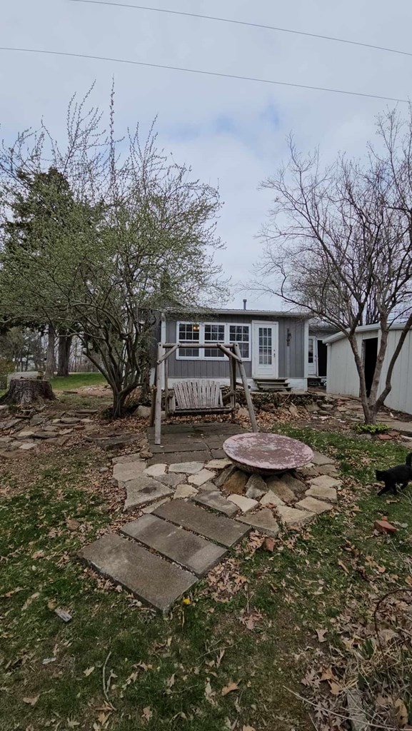 rear view of property featuring a patio area