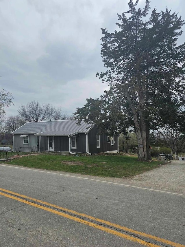 ranch-style house with a front yard and metal roof