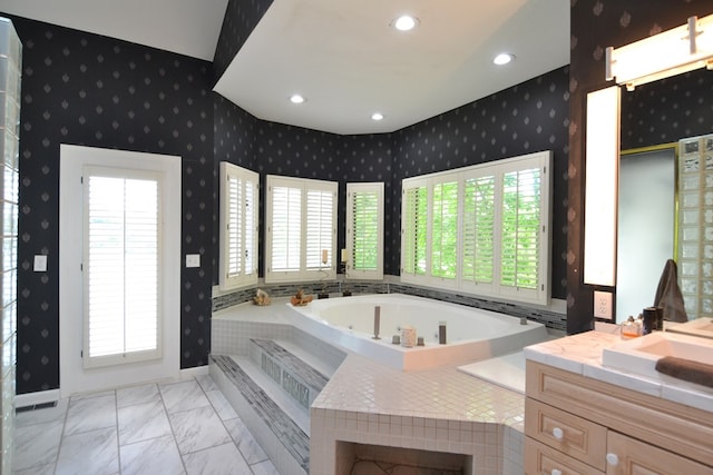 26672 Spring Lake Trl, Kirksville, MO 63501 - bathroom with healthy amount of natural light, a garden tub, wallpapered walls, vanity, and marble look tiles