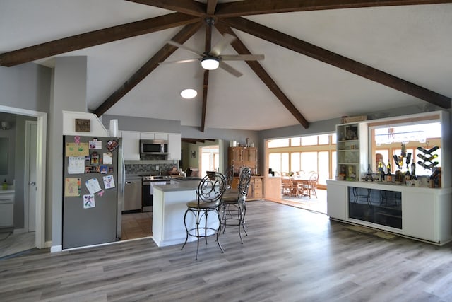 26672 Spring Lake Trl, Kirksville, MO 63501 - kitchen with appliances with stainless steel finishes, beam ceiling, white cabinetry, ceiling fan, and a kitchen breakfast bar