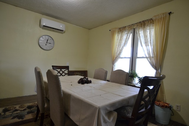 1719 N Osteopathy, Kirksville, MO 63501 - dining space with an AC wall unit, wood finished floors, and a textured ceiling