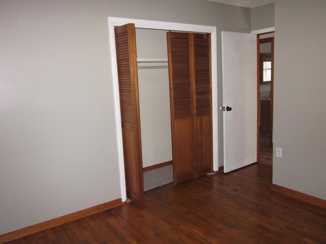 1404 E Washington St, Kirksville, MO 63501 - unfurnished bedroom featuring wood finished floors, a closet, and baseboards