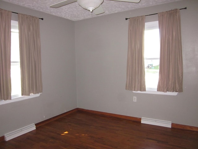 1404 E Washington St, Kirksville, MO 63501 - unfurnished room featuring a baseboard heating unit, a wealth of natural light, a ceiling fan, and baseboards