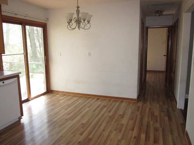 1404 E Washington St, Kirksville, MO 63501 - unfurnished dining area with wood finished floors, baseboards, and an inviting chandelier