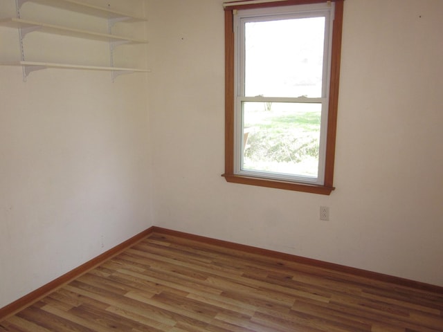 1404 E Washington St, Kirksville, MO 63501 - empty room with baseboards, wood finished floors, and plenty of natural light