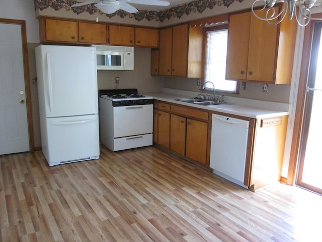 1404 E Washington St, Kirksville, MO 63501 - kitchen featuring light wood finished floors, a sink, white appliances, and light countertops