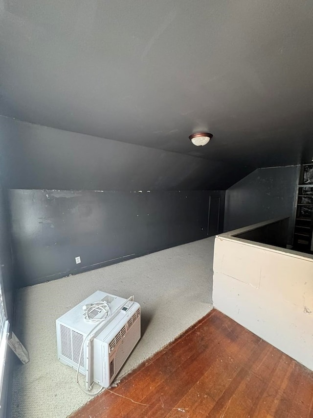 interior space with a wall mounted air conditioner and wood finished floors