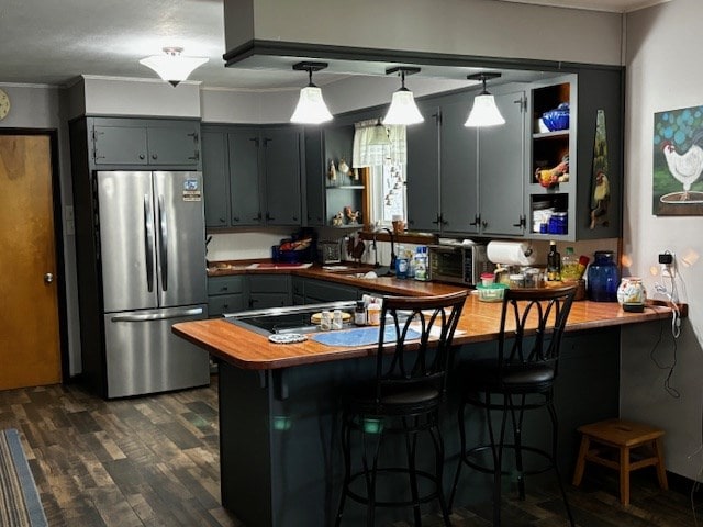 2 Center Dr, Kirksville, MO 63501 - kitchen featuring freestanding refrigerator, a peninsula, open shelves, ornamental molding, and dark wood-style floors