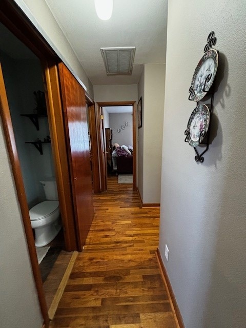 2 Center Dr, Kirksville, MO 63501 - hallway featuring visible vents, baseboards, and wood finished floors