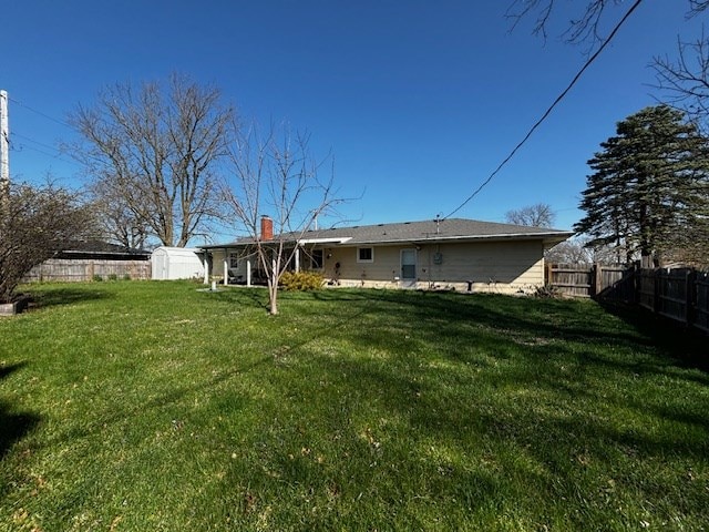 2 Center Dr, Kirksville, MO 63501 - back of property featuring a shed, fence, an outdoor structure, and a lawn