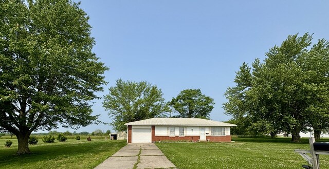 810 S W St, Green City, MO 63545 - view of front facade with a front yard, brick siding, and driveway