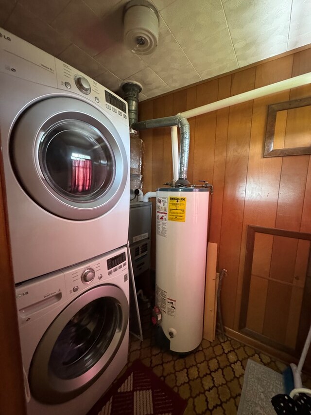 810 S W St, Green City, MO 63545 - washroom with gas water heater, stacked washer / dryer, and wood walls