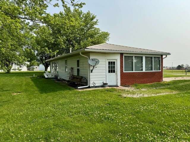 810 S W St, Green City, MO 63545 - back of house featuring a yard, brick siding, and metal roof