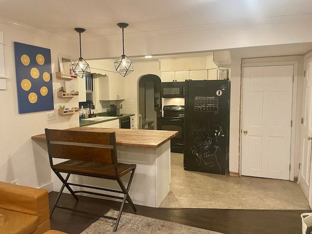 814 E Normal St, Kirksville, MO 63501 - kitchen featuring wood counters, crown molding, a sink, arched walkways, and black appliances