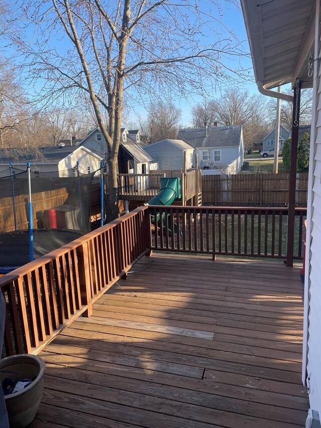 814 E Normal St, Kirksville, MO 63501 - deck with a residential view, a trampoline, a playground, and a fenced backyard