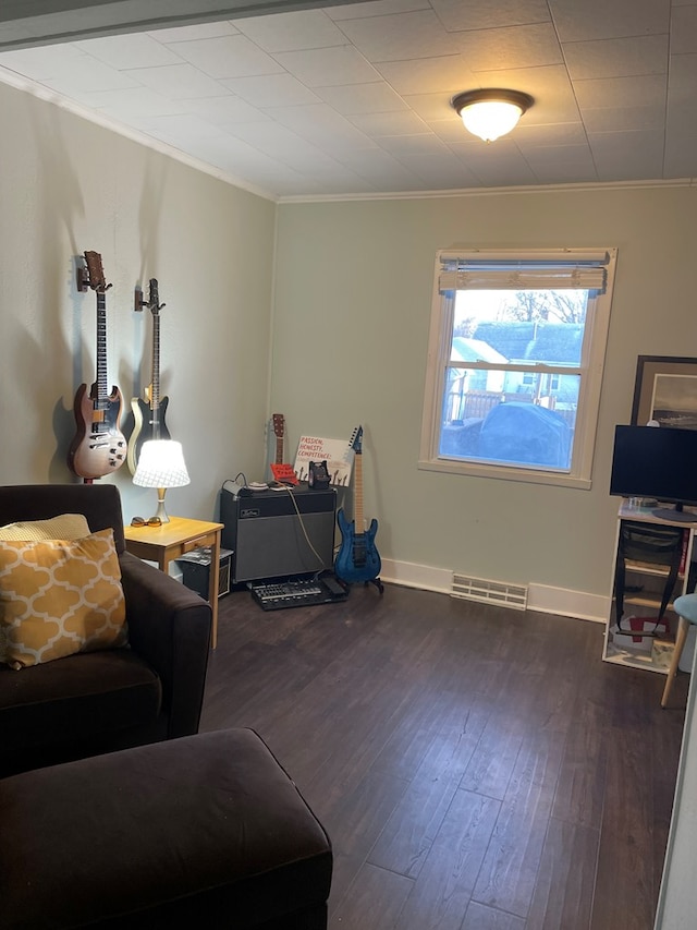 814 E Normal St, Kirksville, MO 63501 - living area featuring dark wood-type flooring, visible vents, crown molding, and baseboards