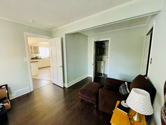 814 E Normal St, Kirksville, MO 63501 - living room with baseboards, visible vents, wood finished floors, and crown molding