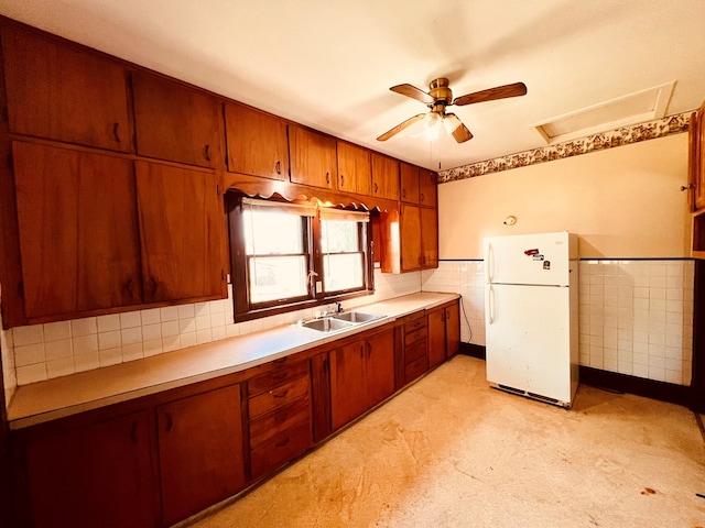 kitchen featuring white refrigerator, ceiling fan, and sink