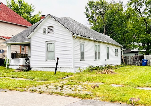 view of side of property with a yard