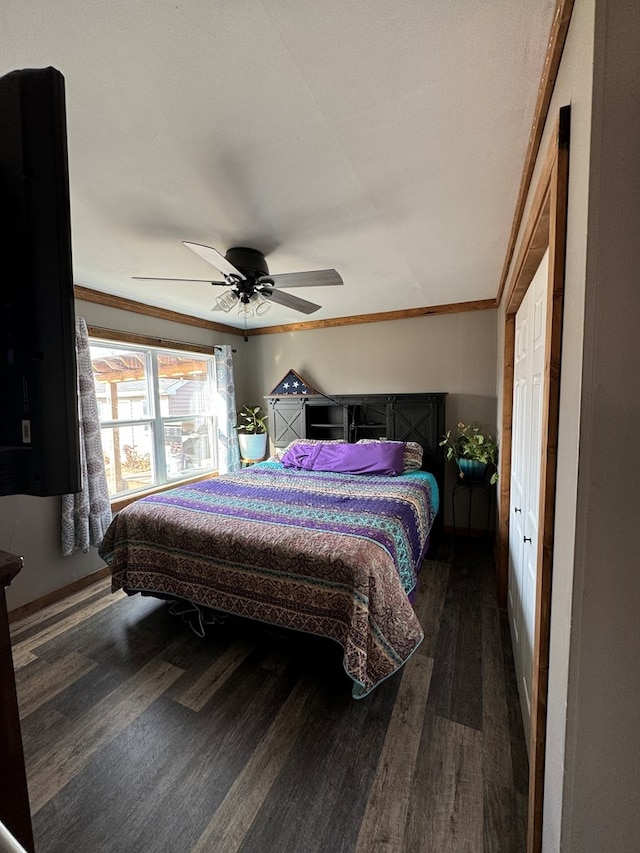 bedroom with crown molding, ceiling fan, and dark hardwood / wood-style flooring