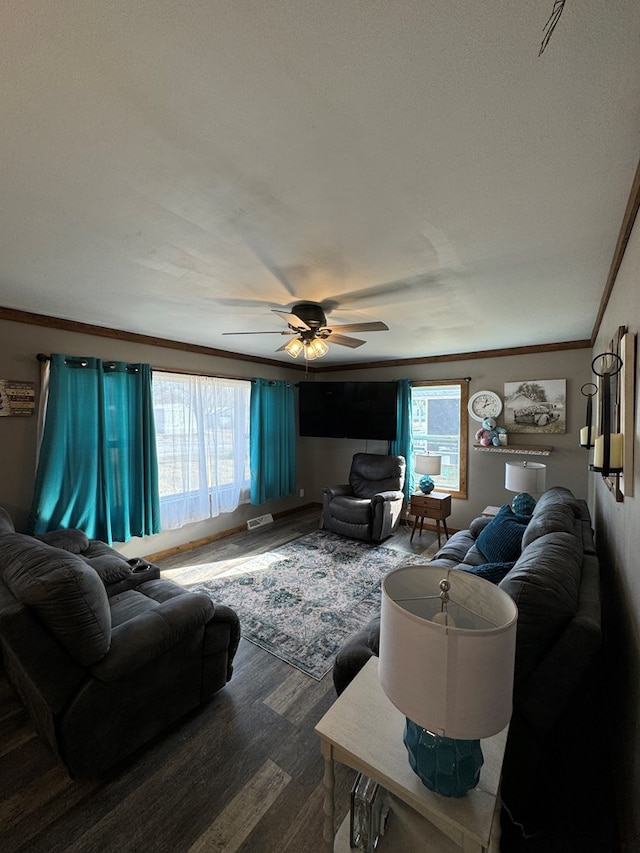 living room with hardwood / wood-style flooring, ceiling fan, and ornamental molding