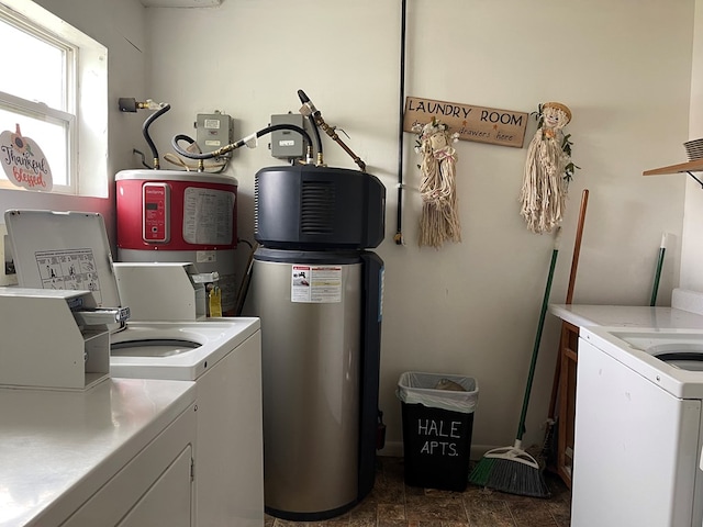 clothes washing area with independent washer and dryer and water heater