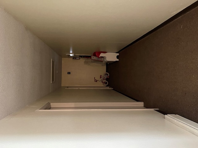 staircase featuring concrete flooring