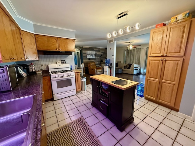 33 Overbrook Dr, Kirksville, MO 63501 - kitchen with gas range gas stove, light tile patterned floors, ceiling fan, and tasteful backsplash