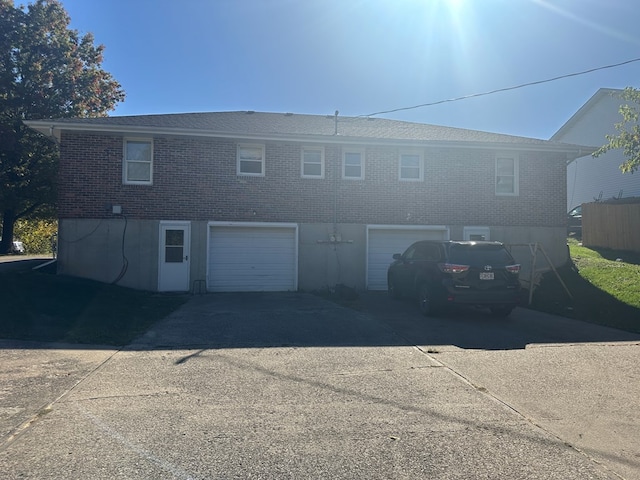 rear view of property featuring a garage