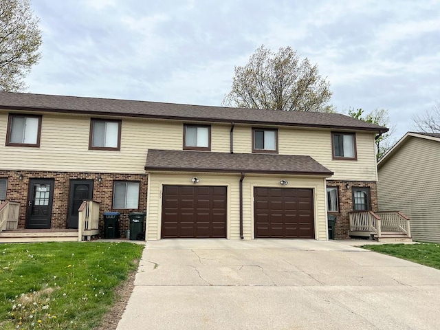 view of property with a front lawn and a garage