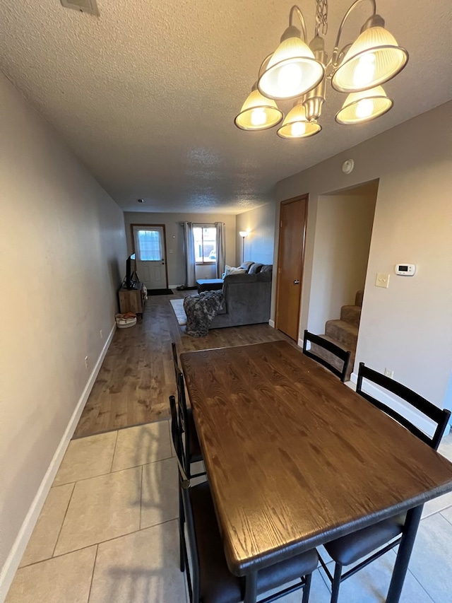 unfurnished dining area featuring tile patterned flooring and a textured ceiling