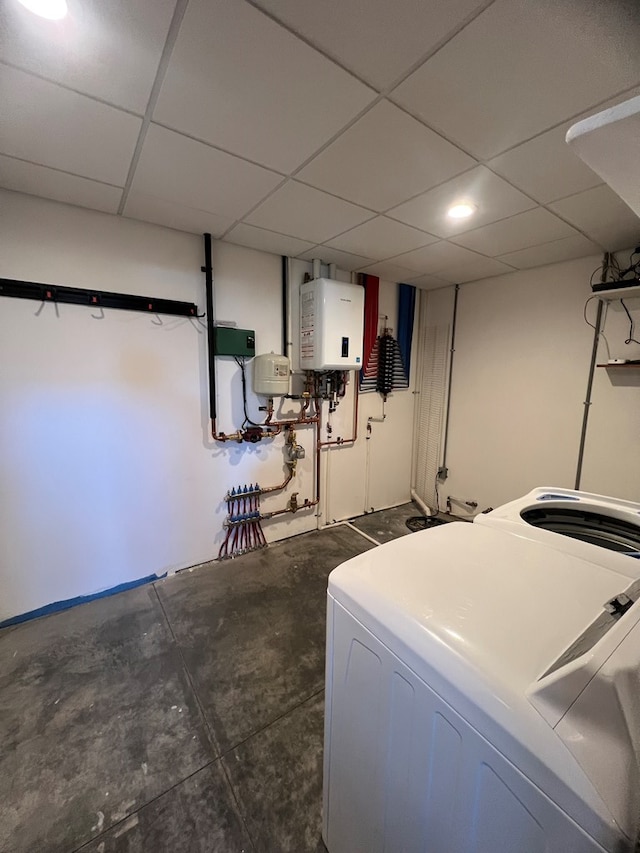 laundry area with laundry area, washer / clothes dryer, and tankless water heater