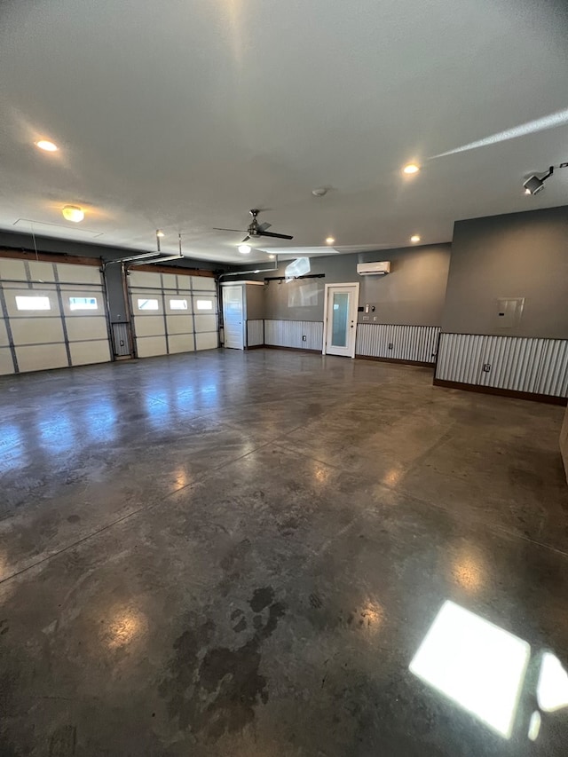 garage featuring a ceiling fan, recessed lighting, and an AC wall unit