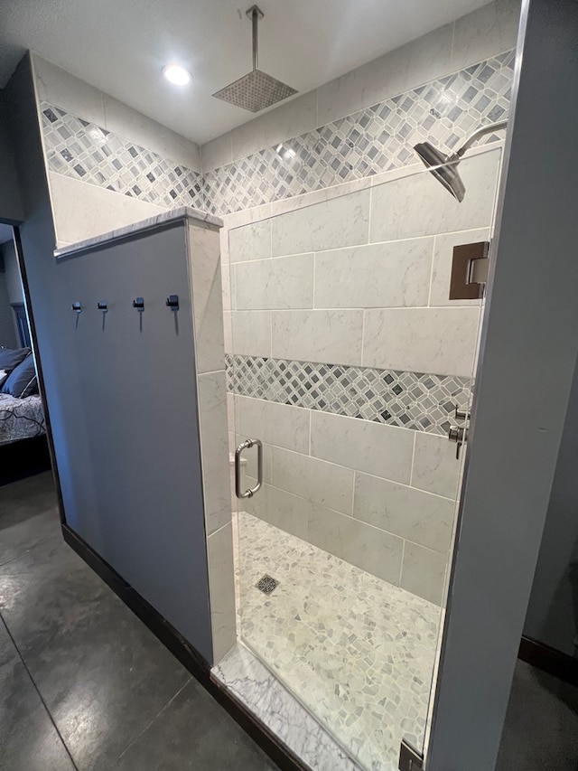 bathroom with a stall shower, connected bathroom, and recessed lighting