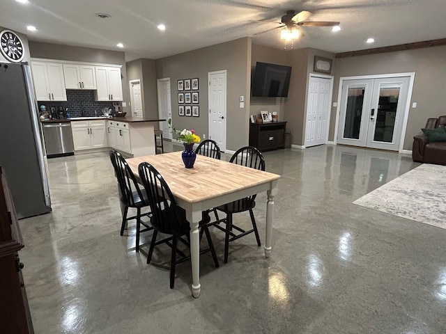 dining space with ceiling fan, a textured ceiling, and french doors