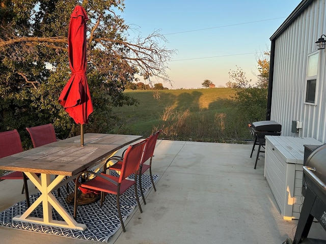 patio terrace at dusk with a grill